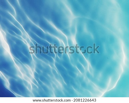 The pattern​ of​ metal​ texture​ on​ surface​ blue​ water​ for​ background. The​ abstract​ of​ blue​ water​ for​ background.  Reflection​ of​ sunlight​ with​ surface​ blue​ water​ for​ background.