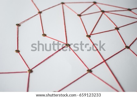 Background. Abstract concept (idea) of network, social media, internet, teamwork,  communication. Thumbtacks linked together by red thread. Isolated. Entities connected.