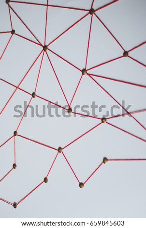 Background. Abstract concept (idea) of network, social media, internet, teamwork,  communication. Thumbtacks linked together by red thread. Isolated. Entities connected.