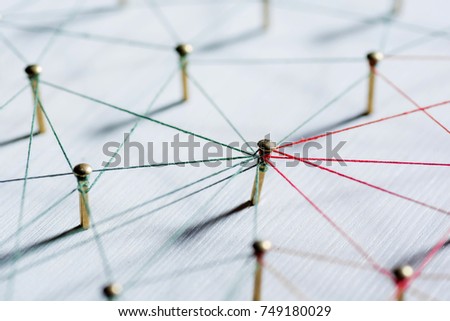 Background. Abstract concept idea of network, social media, internet, teamwork, communication. Thumbtacks linked together by red thread. Isolated. Entities connected.