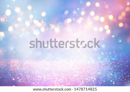 background of abstract glitter lights. blue, pink, gold and silver. de focused