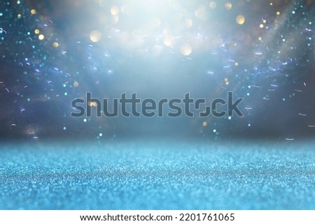 background of abstract glitter lights. silver, blue and black. de focused