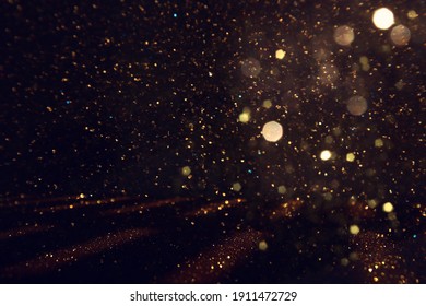 background of abstract gold and black glitter lights. defocused - Shutterstock ID 1911472729