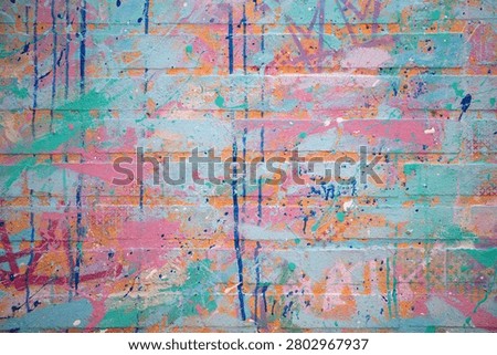 Background abstract painted brick texture. Background colorful urban wall pattern. Background creative graffiti surface design. Background modern artistic backdrop.