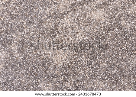 Background Abstract texture. Pebbles small or gravel color black, brown attached with beautiful cement concrete. Natural pattern used to make wallpaper website along walls of houses, building.