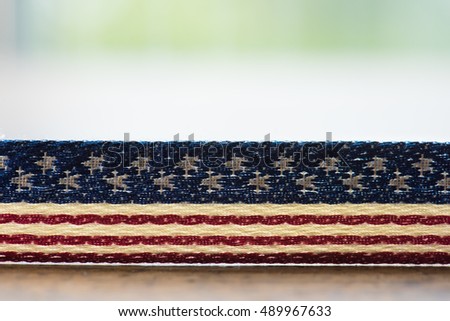 Background for American election or commemorative event. A textile with stars and stripes pattern on table.