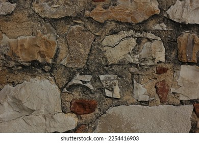 Background of an ancient brick wall, consisting of different stones and pieces of marble - Shutterstock ID 2254416903