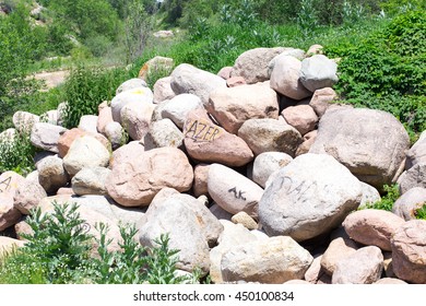 Background with artificial grass and stone. In the foreground is big stones.