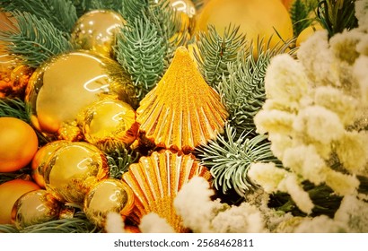 Background or backdrop made of closeup view of traditional fir christmas tree branch decorated with gold and yellow balls decor and baubles used as winter holidays celebration season decoration