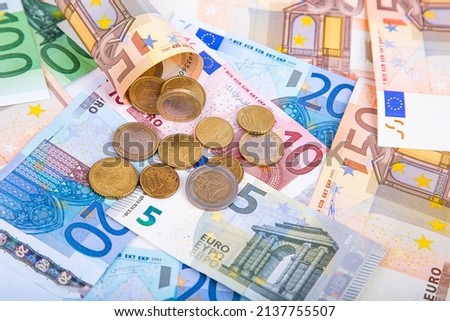 Background of banknotes and euro coins of different denominations close-up