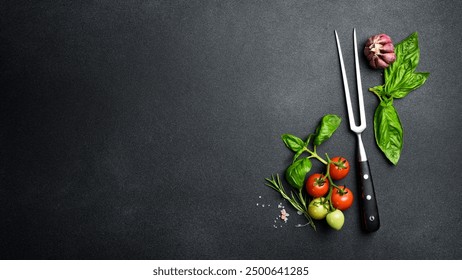 Background of the barbecue. Meat fork, kitchen utensils, salt, pepper and spices on table surface. Free space for text. Top view.