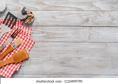 Background with BBQ cooking tools on wood background.