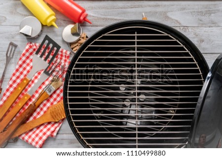 Background with BBQ cooking tools on wood background.