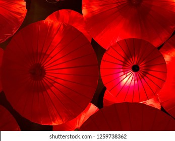 background of beautiful Asian traditional decoration with red umbrellas hanging on the ceiling, interior design element of celebration Japanese Chinese Vietnam style, display of Asian culture symbol - Powered by Shutterstock