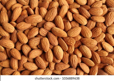 Background of big raw peeled almonds situated arbitrarily - Shutterstock ID 1036889638