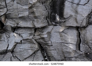 Background Of Black And Grey Charcoal With Deep Cracks