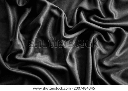 background of black wrinkle shiny cloth texture can be use as background