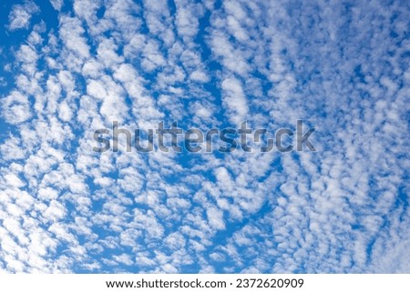 Background of blue sky with pieces of white clouds on a summer sunny day.