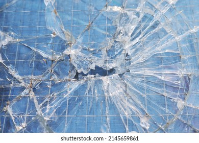The background is blue  tinted texture broken glass and selective focus  The glass and metal bars cracked 