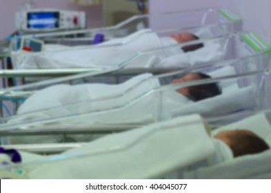 Background Blur Newborns In Incubators. Couch After Birth In Hospital.