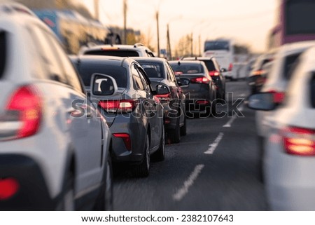 Background, blur, out of focus, bokeh. Traffic jams during rush hours after work. Red brake lights of stopped cars on the background of the city neighborhood.