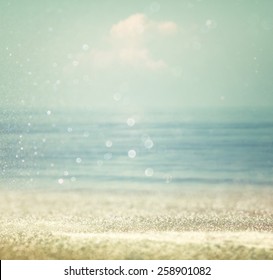 Background Of Blurred Beach And Sea Waves With Bokeh Lights, Vintage Filter. 