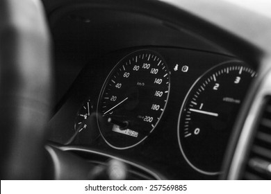 background blurred view of the dashboard with speedometer in the car