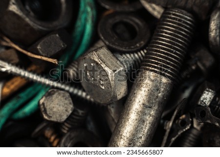 Background with bolts, screws and other repair parts in close-up. Metal parts for various repairs. Macro of recycled metal bolts. High quality photo