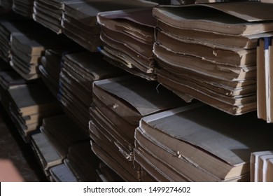 Background With Books And Bookshelves In A Dark Library Archive Room. The Concept Of Historical Studies Back To School And Getting Knowledge. Blurred Background. Selective Focus.