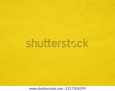Background of bright yellow felt. Yellow cotton textile- close up of fabric texture. Full frame backdrop wallpaper of art and stationery work. Velvet pattern of mint woolen felt. Full frame wallpaper.