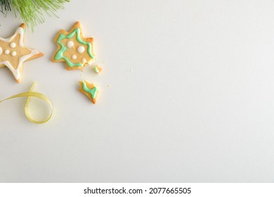 Background With Broken Christmas Cookie On White Table Ribbon Fir Branches. Top View. Horizontal Composition.