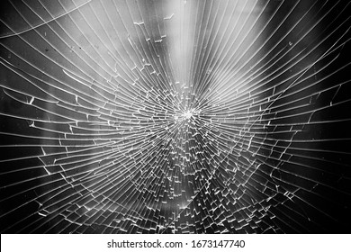 Background broken glass shine in the shape of a spider web