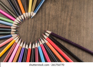 Background Of Bunch Of Colored Pencils On Black Paper The Idea Of Concentration And Attraction To Nucleus Center Circle Radius Unity Concept Of Leadership, Community, The Team Focused On One Goal