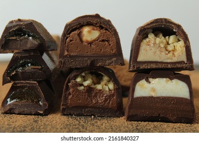 background of candy candy chocolate. sweets in section with fillings of praline ganache with peanuts whole crushed close-up. A day without diet sweet day chocolate. - Shutterstock ID 2161840327