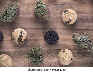 Background With Cannabis Nugs (forum Cut Cookies Strain) Over Infused Chocolate Chips Cookies - Medical Marijuana Edibles Concept