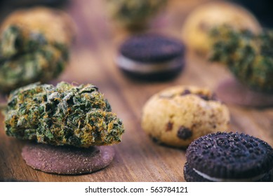 Background With Cannabis Nugs Over Infused Chocolate Chips Cookies - Medical Marijuana Edibles Concept