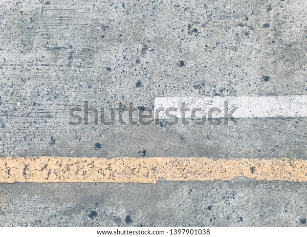 Background - cement road with yellow and white\
traffic dividing\
line