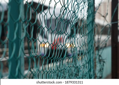 Background Of Chain Link Fence And Blurred Light Rail Train Backdrop                              