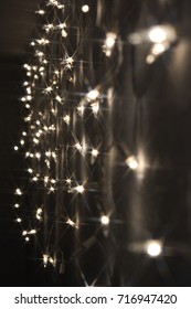 Background With Christmas Lights On A White Wall.