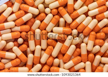 Background - close up of countless colourful orange medicine  pills
