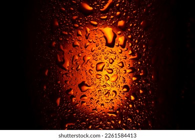 background. close up. drops on a glass with an orange drink. beer, tea - Powered by Shutterstock