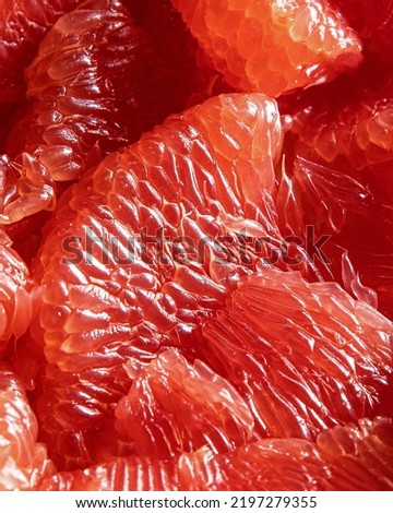 Background - close-up of peeled red grapefruit segments