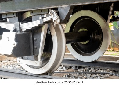 Background closeup of steel train wheels on the railroad. steel wagon train wheels.  locomotive wheels close up. sstkbackground. Pair of wheels on tracks. Iron railroad. Industrial transportation. - Powered by Shutterstock