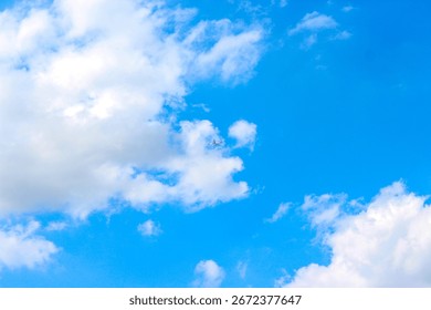 Background with clouds on blue sky. Sky view. Beautiful sunny sky. Clouds on blue sky. Sun shining through the puffy clouds. Airplane in the clouds.