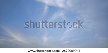 Background with clouds on blue sky. Sky view. Beautiful sunny sky. Clouds on blue sky. Sun shining through the puffy clouds.