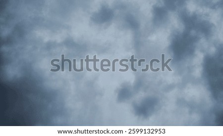 The background is a cloudy sky with cumulus clouds from the bottom view which is a sign that rain will fall.