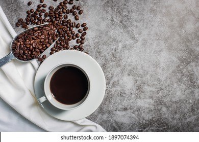 Background Coffee Cup And Beans On Old Kitchen Table. Top View With Copyspace For Your Text