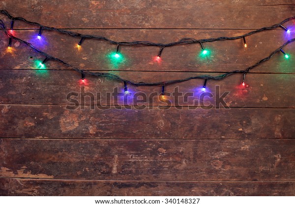 Background Colorful Christmas Lights On Rustic Stock Photo