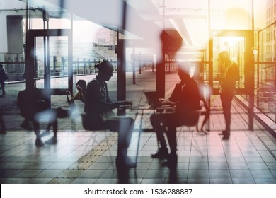 Background concept with business people silhouette working in the office near a window glass. Double exposure and light effects