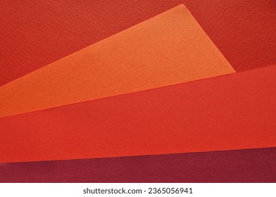 Background concept. Combinations of multi-colored sheets of orange, pink andcolored paper in different shades. Copy space, top view, background.
